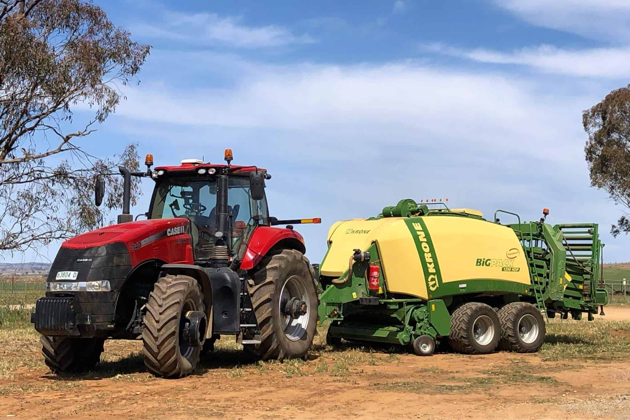 A tractor sits in a paddock ready to tow farm equipment
